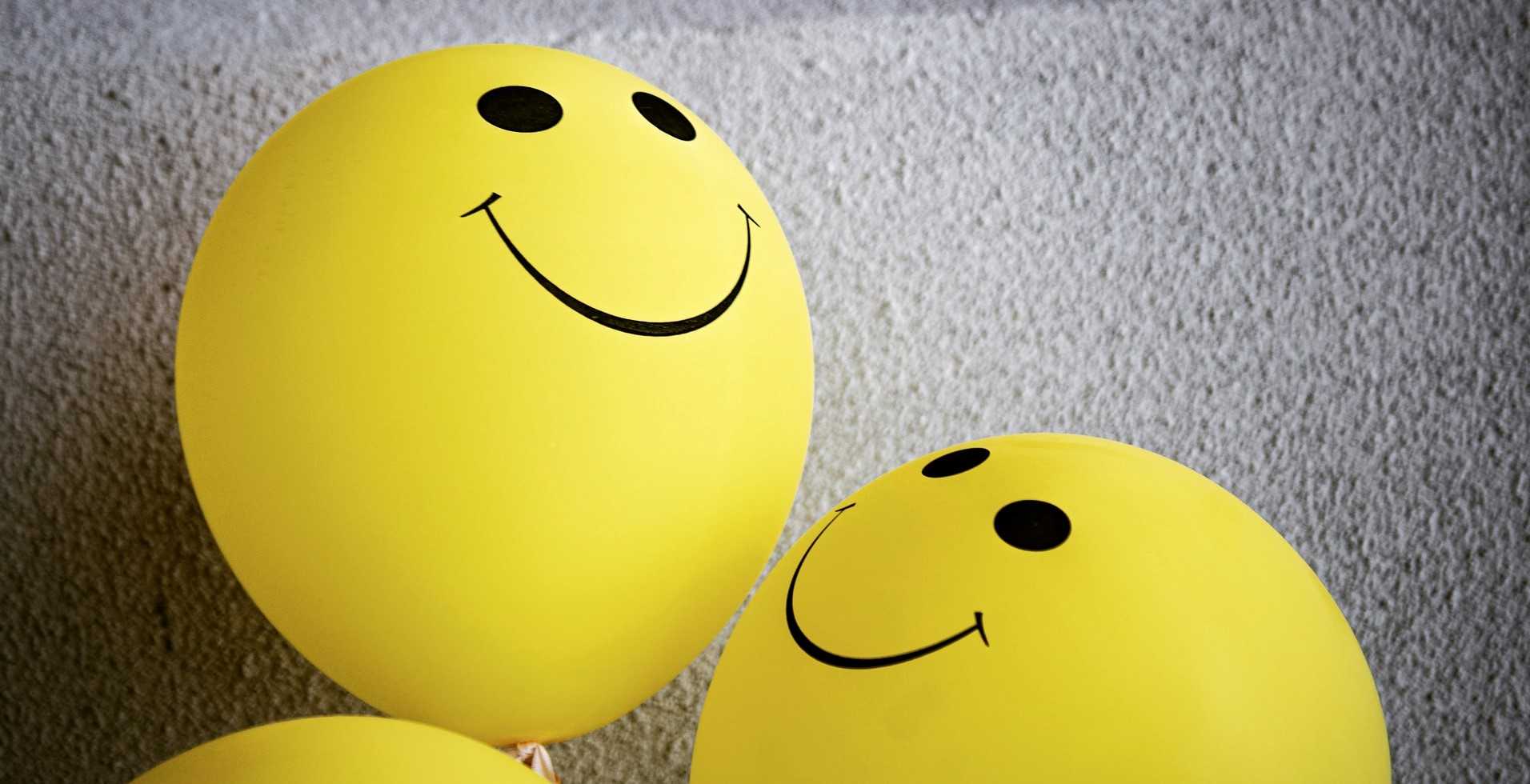 yellow balloons with smiles drawn on